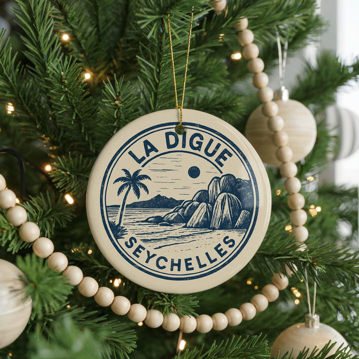 A Christmas tree decorated with ornaments, including a circular ornament with a palm tree and a beach scene, and a beaded ornament.