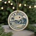 A circular ornament with the text "LA DIGUE SEYCHELLES" and a palm tree illustration, hanging from a string.