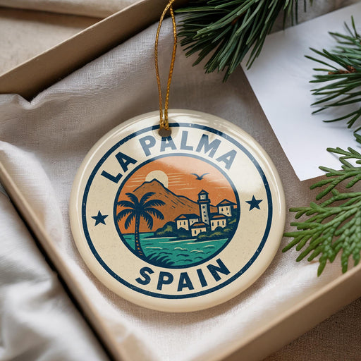 A circular ornament with the text "LA PALMA SPAIN" and an illustration of a beach and palm trees, hanging from a string.