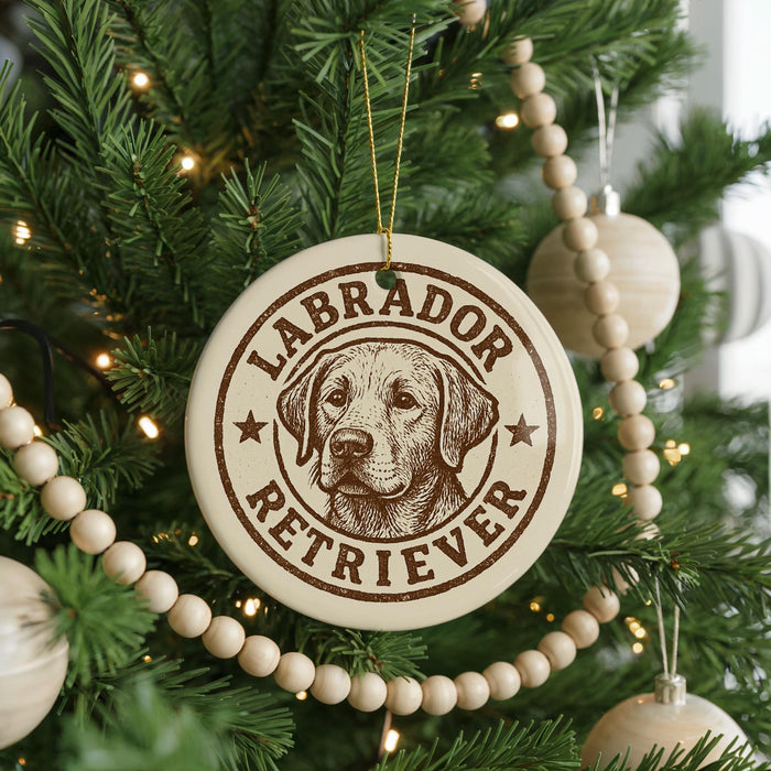 A circular ornament on a Christmas tree featuring a Labrador Retriever dog's face, with the text "Labrador Retriever" around the edge.