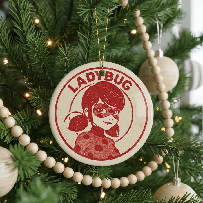 A Christmas tree decorated with ornaments, including a circular ornament featuring a character from the anime series Ladybug.