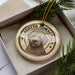 A circular ornament featuring a dog's face, with the text "LAGOTTO ROMAGNOLO" around the edge.