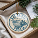 A circular ornament with the text "LAKE BAIKAL RUSSIA" printed on it, hanging from a string.