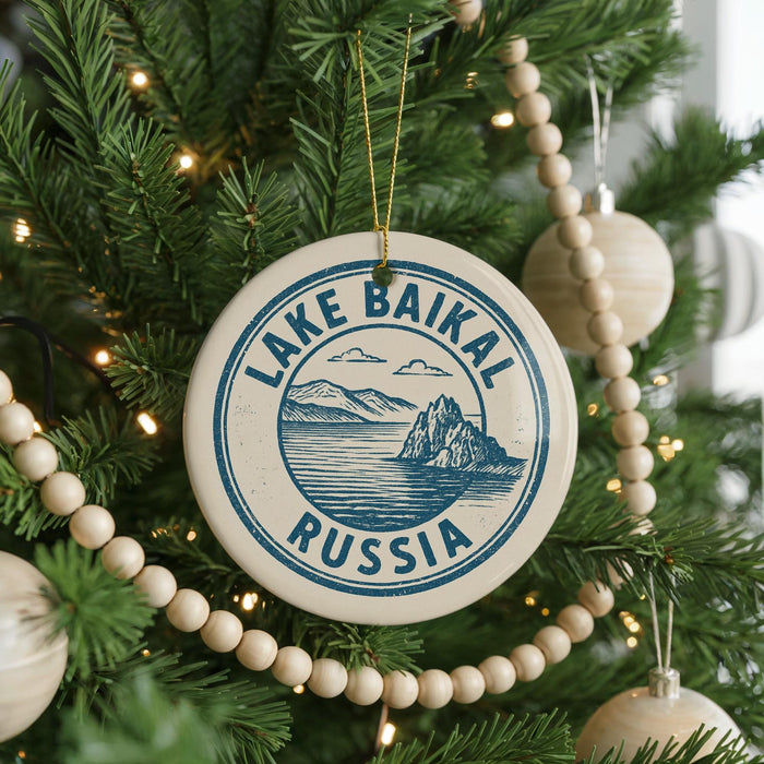 A circular ornament on a Christmas tree, featuring the text "LAKE BAIKAL RUSSIA" and an illustration of a lake and mountains.