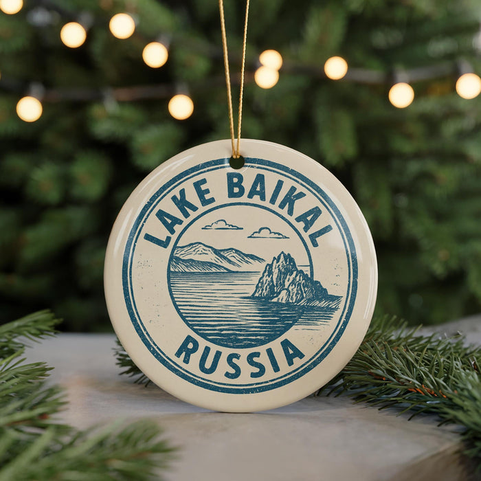 A circular ornament with the text "LAKE BAIKAL RUSSIA" printed on it, hanging from a string.