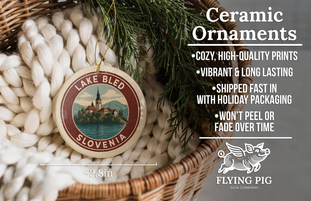 Ceramic ornaments, featuring a lake and a castle, are displayed in a basket with greenery.