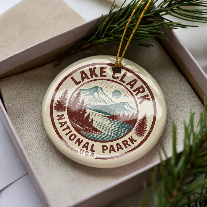 A circular ornament with the text "LAKELAND NATIONAL PARK USA" printed on it, surrounded by pine branches.