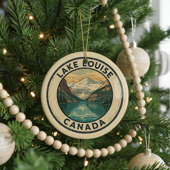 A circular ornament on a Christmas tree, featuring a scenic image of Lake Louise and the Canadian Rockies.