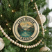 A circular ornament on a Christmas tree, featuring a scenic image of Lake Louise and the Canadian Rockies.