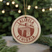 A circular ornament with the text "LALIBEZA" and "ETHIOPIA" printed on it, hanging from a string.