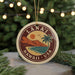 A circular ornament with the text "LÁNÂI HAWAII, USA" and a tropical landscape design, hanging from a string.