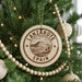 A circular ornament on a Christmas tree, featuring the text "LANZAROTE SPAIN" and a mountain landscape design.