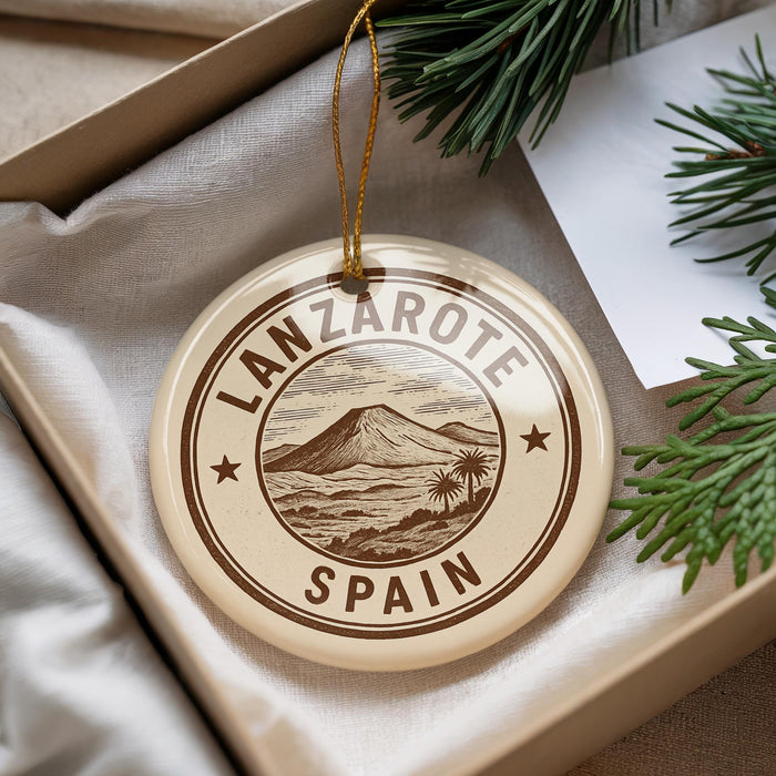 A circular ornament with the text "LANZAROTE SPAIN" printed on it, surrounded by a border and a tree branch.