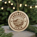 A circular ornament with the text "LANZAROTE SPAIN" printed on it, featuring a mountain and palm trees.