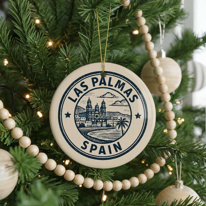 A circular ornament on a Christmas tree, featuring the text "LAS PALMAS" and "SPAIN" along with an illustration of a cityscape.