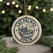 A circular ornament with the text "LAS PALMAS" and "SPAIN" printed on it, featuring a graphic of a cityscape and palm trees.
