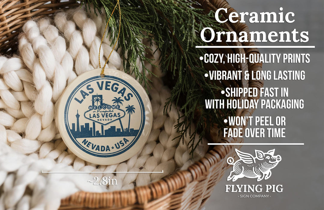 Ceramic ornaments, including a round ornament with a city skyline design, are displayed in a woven basket.