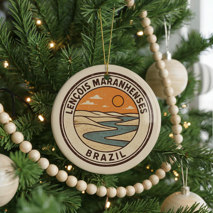 A circular ornament on a Christmas tree, featuring a landscape with a river and mountains, along with the text "LENCÔS MARANHENESES BRAZIL".