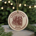 A circular ornament featuring a brown dog's head and the text "LEONBERGER DOG" is displayed in front of a blurred Christmas tree.