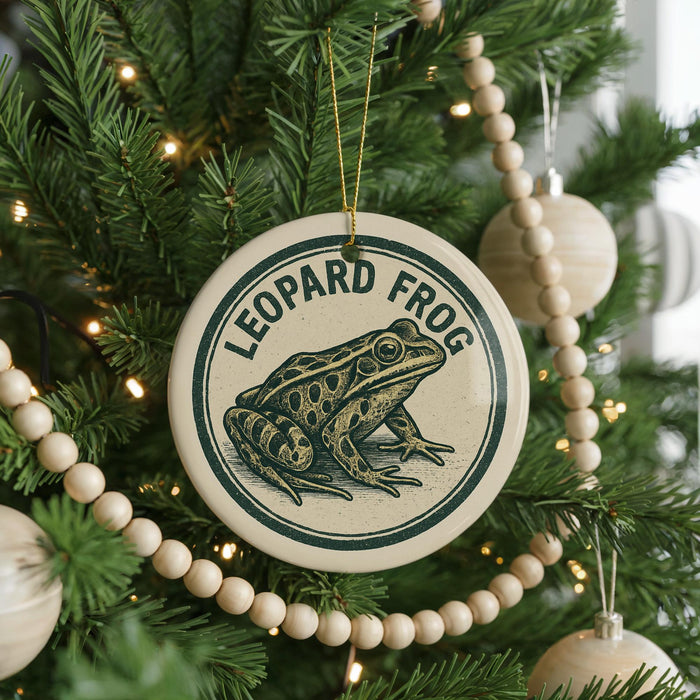 A Christmas tree decorated with ornaments, including a circular ornament with a leopard frog design and the text "LEOPARD FROG" on it.