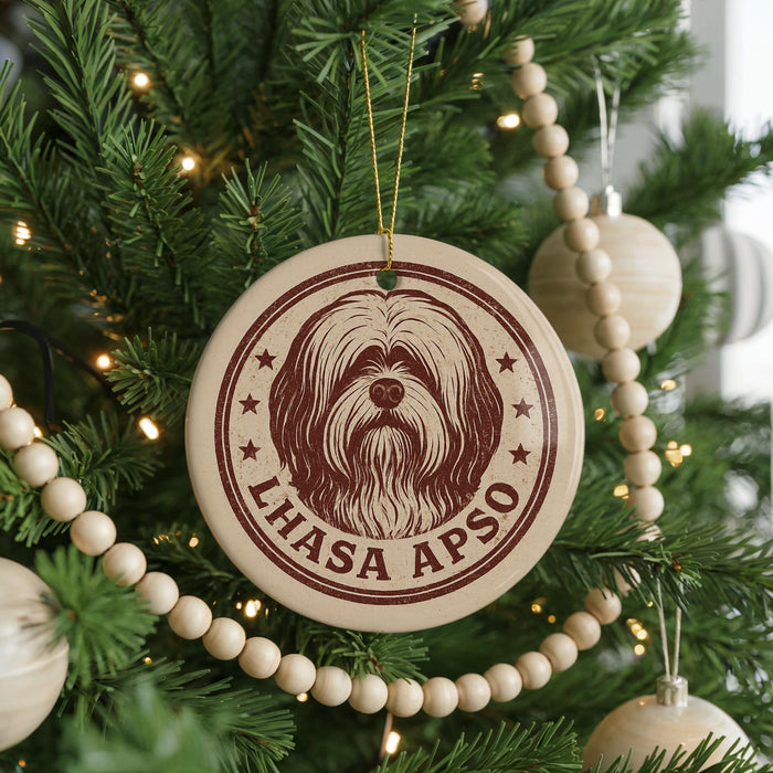 A Christmas tree decorated with ornaments, including a circular ornament with a dog's face and the text "LHASA APSO" printed on it.
