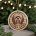 A circular ornament featuring a dog's head and the text "LHASA APSO" is displayed in front of a blurred Christmas tree with twinkling lights.