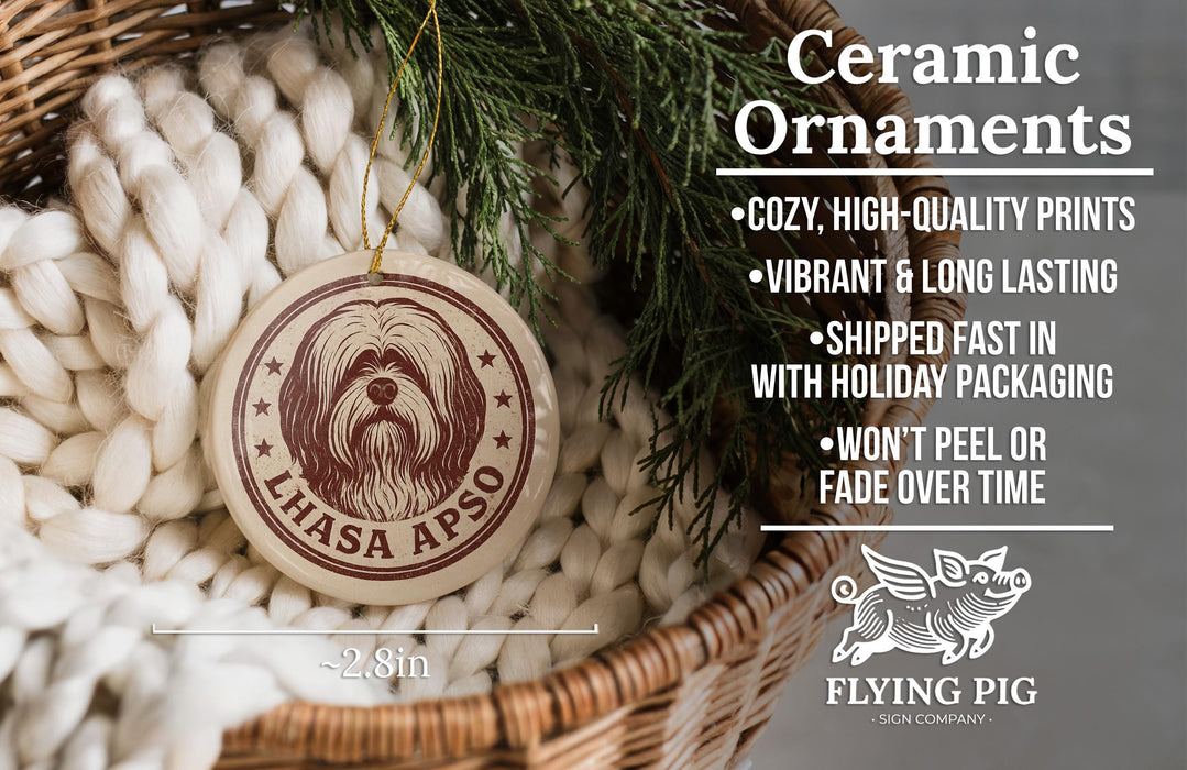 Ceramic ornaments, featuring a round ornament with a dog image and text, are displayed in a wicker basket.