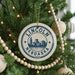 A circular ornament on a Christmas tree, featuring the text "LINCOLN NEBDAKA USA" and a graphic of a city skyline.