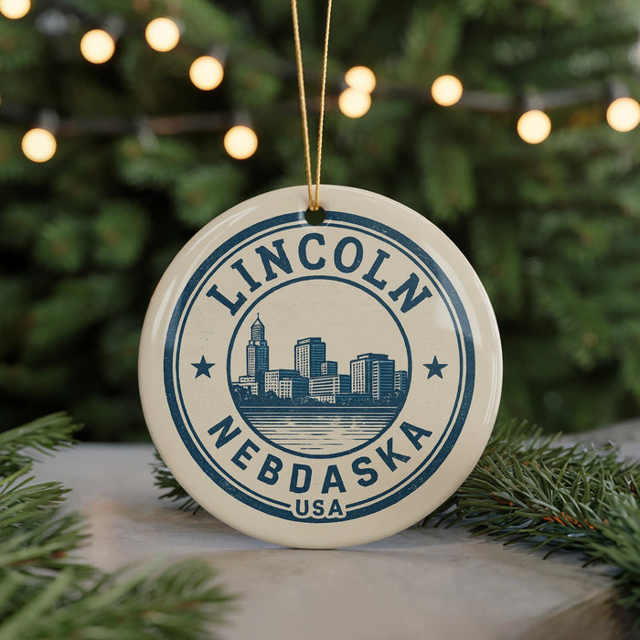 A circular ornament with the text "LINCOLN NEBDAKA USA" and a graphic of a city skyline, hanging from a string.