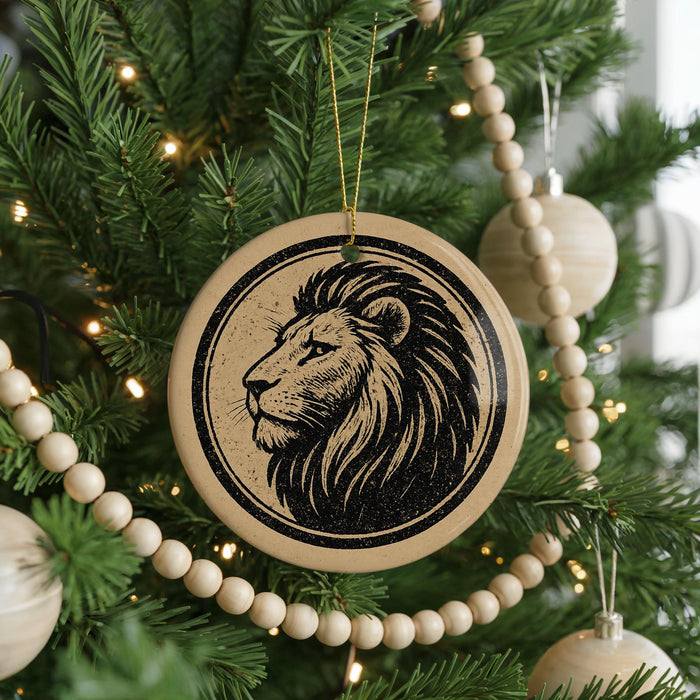 A Christmas tree decorated with ornaments, including a circular ornament featuring a lion's head design.