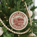A Christmas tree decorated with ornaments, including a circular ornament with the text "LJUBLJANA SLOVENIA" on it.