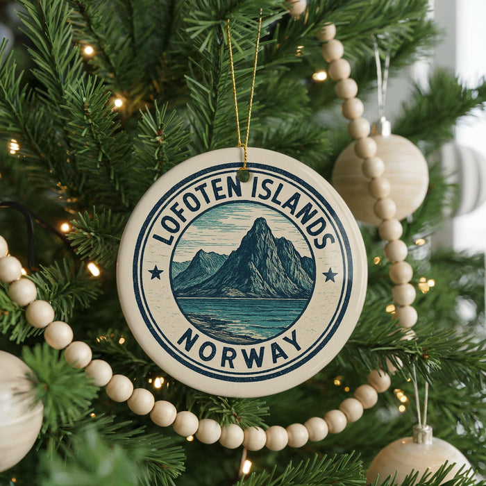 A Christmas tree decorated with ornaments, including a circular ornament with the text "Lofoten Islands Norway" and a mountain landscape.