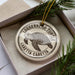 A ceramic ornament in a box, featuring a turtle design and the text "Loggerhead Turtle" and "Caretta Caretta".