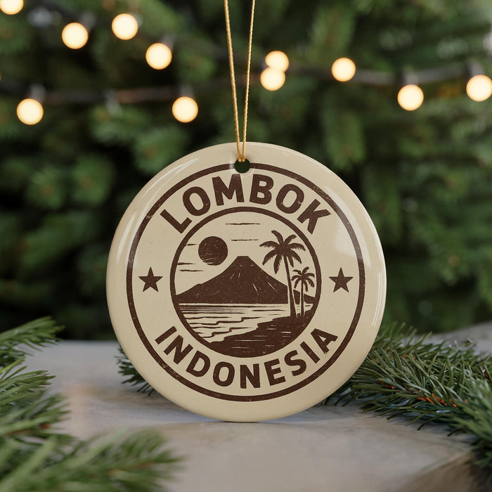 A circular ornament with the text "LOMBOK INDONESIA" and a graphic of a mountain, palm tree, and beach, hanging from a string.