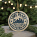 A circular ornament with the text "LONG BEACH CALIFORNIA USA" printed on it, featuring a graphic of a city skyline.
