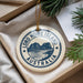 A circular ornament with the text "LORD HOWE ISLAND AUSTRALIA" printed on it, hanging from a string.
