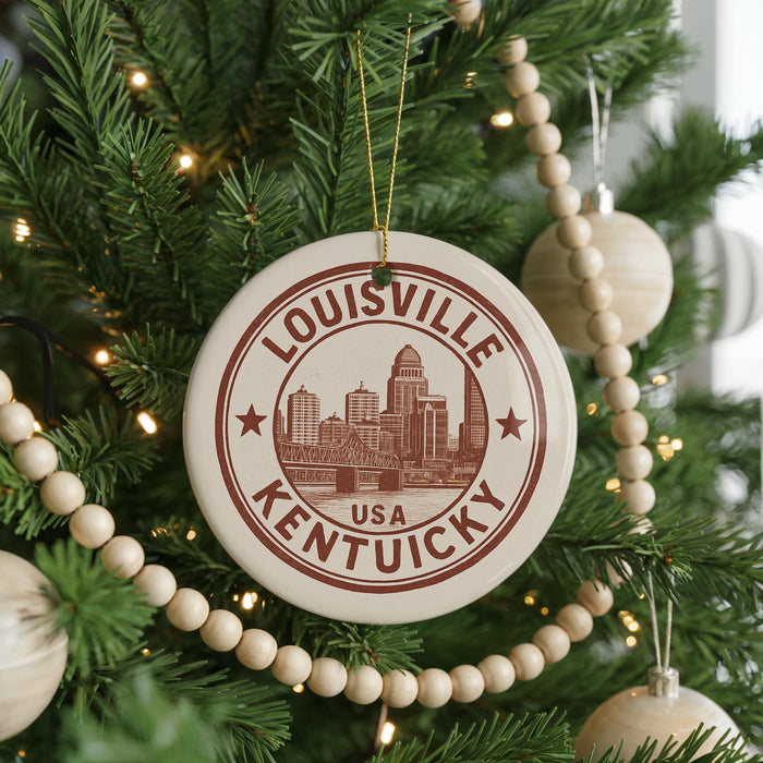 A Christmas tree decorated with ornaments, including a circular ornament with the text "LOUISVILLE KENTUCKY" and a cityscape illustration.