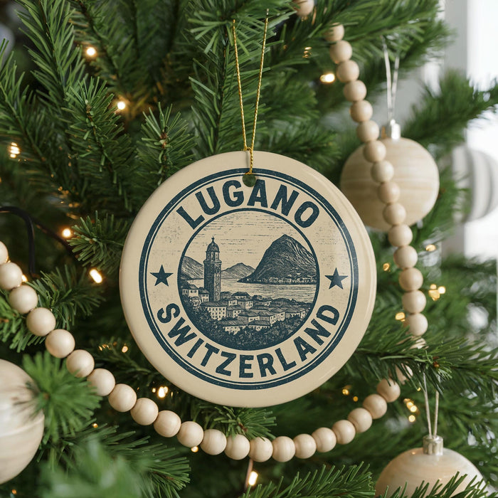 A Christmas tree decorated with ornaments, including a circular ornament with the text "LUGANO SWITZERLAND" and a mountain illustration.