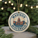 A circular ornament with the text "MADISON, WISCONSIN, USA" and an illustration of the Madison, Wisconsin skyline.