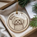A round ornament with a Maltese dog image on it, hanging from a string.