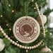 A Christmas tree decorated with ornaments, including a circular ornament with the text "MAMMOTH CAVE NATIONAL PARK" printed on it.