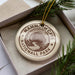 A decorative ornament in a box, featuring the text "MAMMOTH CAVE NATIONALL PARK" and an illustration of a cave surrounded by trees.