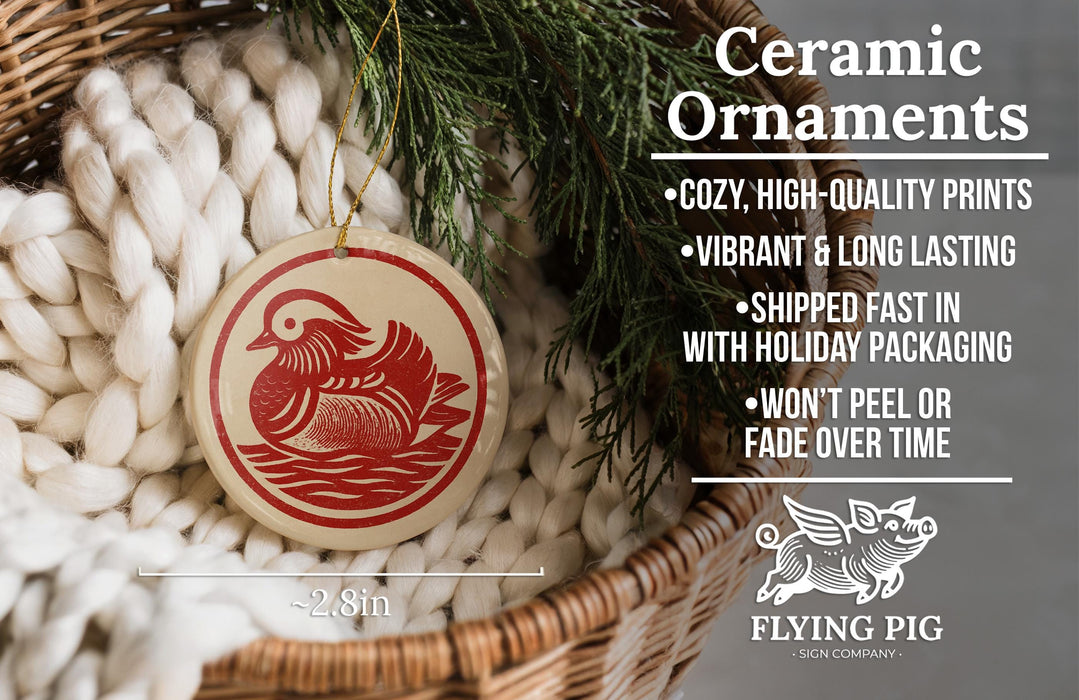 Ceramic ornaments, featuring a ceramic ornament with a red bird design, are displayed in a wicker basket.