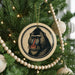 A Christmas tree decorated with ornaments, including a circular ornament featuring a monkey's face.