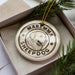 A circular ornament with the text "MAREMA SHEPP dog" printed on it, surrounded by a decorative border.