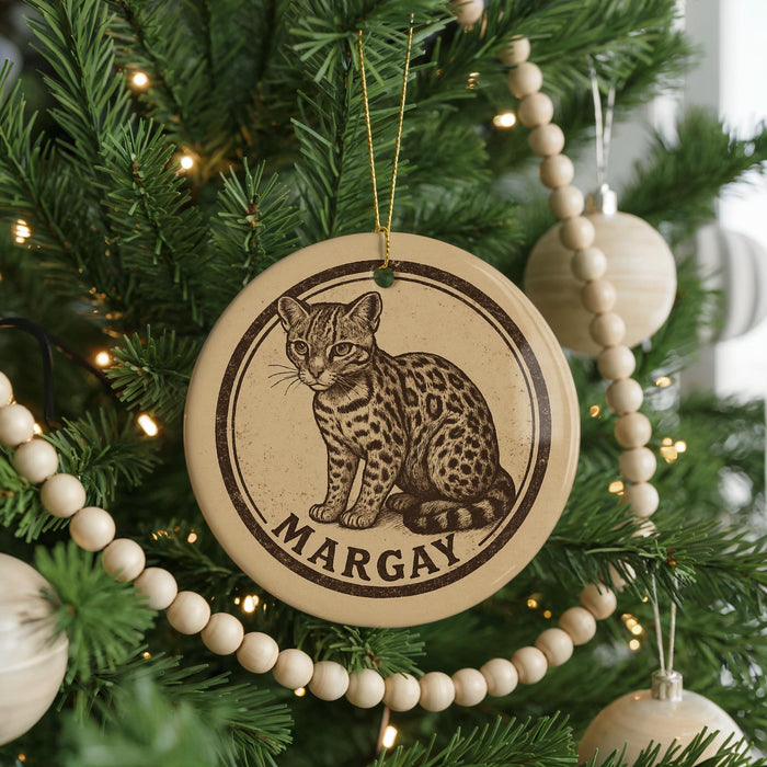 A Christmas tree decorated with ornaments, including a circular ornament with a cat image and the name "MARGAY" written on it.