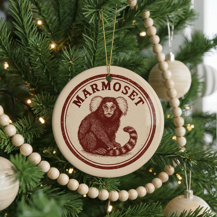 A round ornament with a monkey on it, hanging on a Christmas tree.