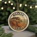 A circular ornament with the text "MASADA ISRAEL" and an illustration of a mountain or hill, hanging from a string.