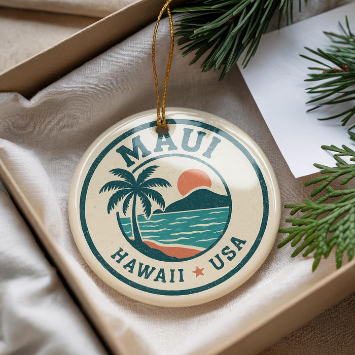 A circular ornament with the text "MAUI HAWAII * USA" and a palm tree design, hanging from a string.