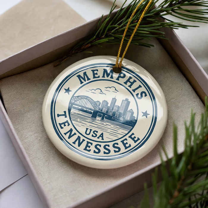 A circular ornament with the text "MEMPHIS TENNESSEE USA" printed on it, surrounded by pine branches.